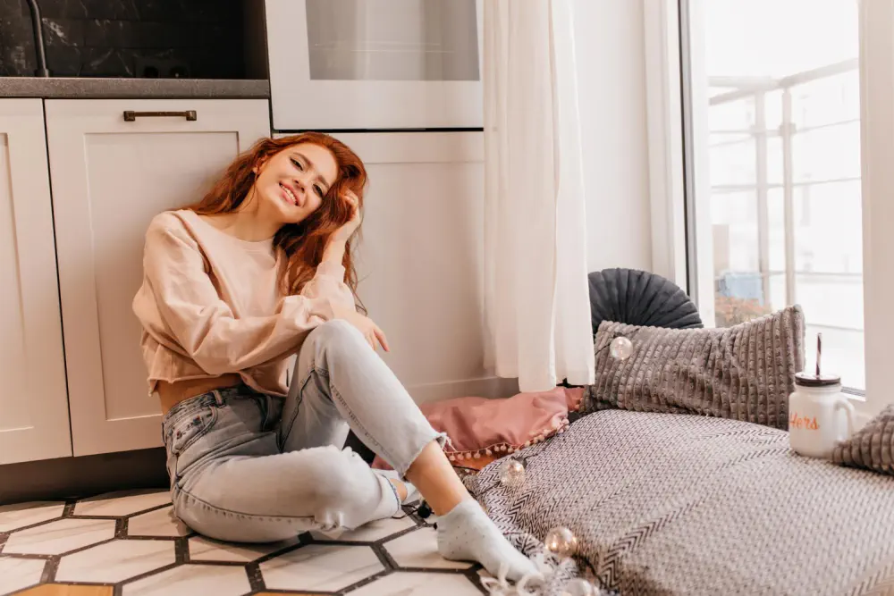 Woman sitting on a kitchen floor, illustrating early alcohol withdrawal.