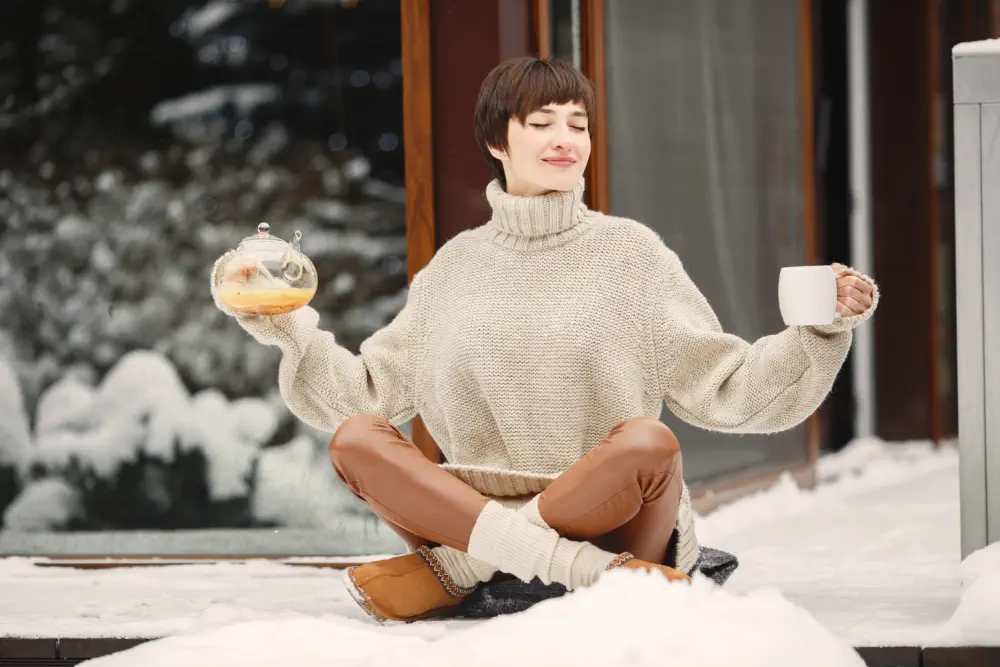 Woman with tea in snow.