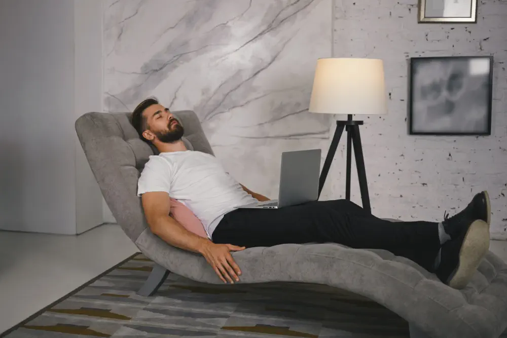 Man slumped in a chair, representing extreme lethargy from high-dose edibles.